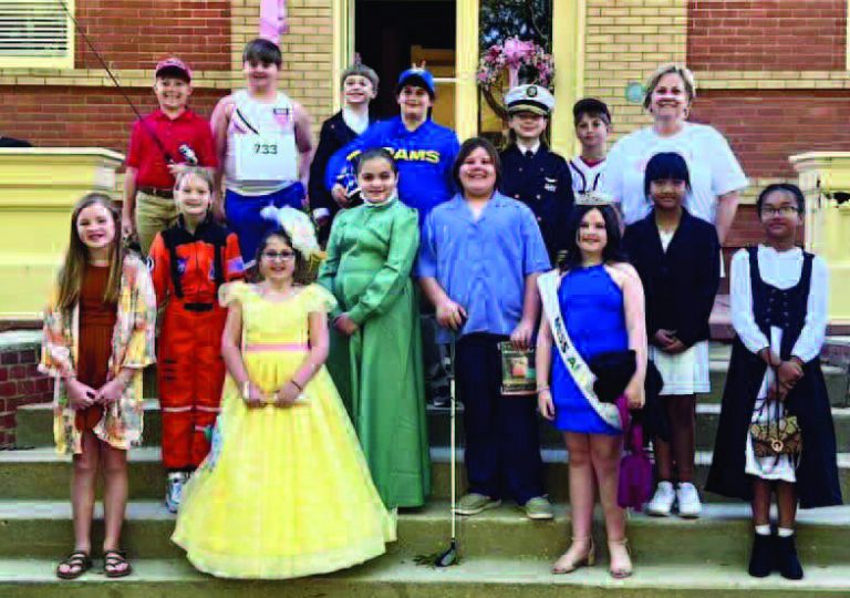 PORTRAY FAMOUS PEOPLE- Members of the 4th grade class at The Lakeside School in Eufaula were assigned the task of choosing a famous individual from Alabama. The student was then responsible for researching the individual they chose in class. During the recent Eufaula Pilgrimage, students were able to share what they learned about the person, dress in character of the famous person for visitors and locals during the Pilgrimage at the Carnegie Library. Students shown during the Pilgrimage in front of the library, left to right, on the first steps, are Emerson Phillips portraying Emmylou Harris, Jolie Robinson portraying Wileyna Shorter, Eva Pappas portraying Katherine Webb and Ammy Thawng portraying Emma Sansom; on the 2nd row of steps, left to right, are Coral Claypole portraying Mae Jemison, Rylie Hatton portraying Helen Keller, Serra Blakely Robertson portraying Harper Lee, Eve Sung portraying Lurleen Wallace; on the third row steps, left to right, are Rowdy Wright portraying Tom Mann, Jase Goins portraying esse Owens, Tatum Bradley portraying John Gill Shorter, Max Osmer portraying Les Snead, Maddox Mogren portraying Admiral Thomas H. Moorer, JT Pate portraying Hank Aaron, and Mrs. Denise Corcoran, 4th grade teacher/sponsor.